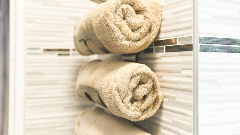 Neatly organized rolled up towels on a rack