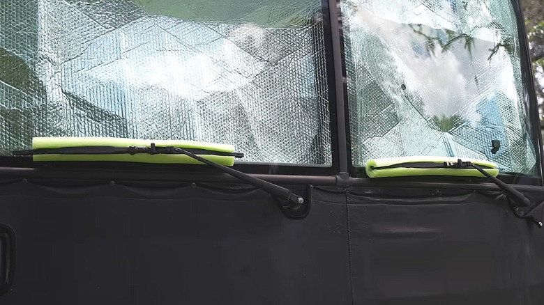 RV with pool noodles on the windshield wipers