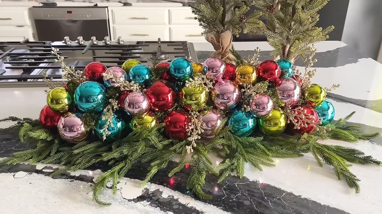 Ornament-covered centerpiece using a pool noodle as the base sitting on a kitchen countertop