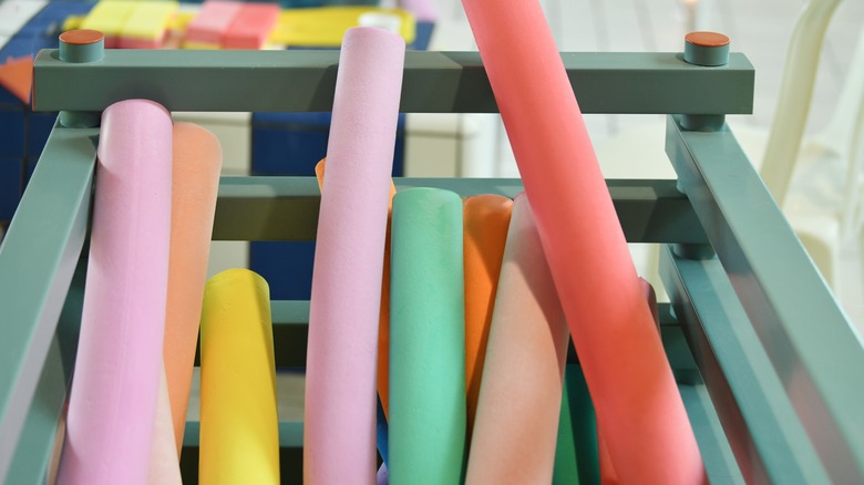 Container of multi-colored pool noodles