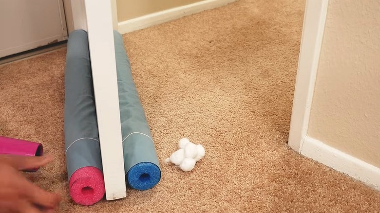 Draft blocker on a door made of two pool noodle sections