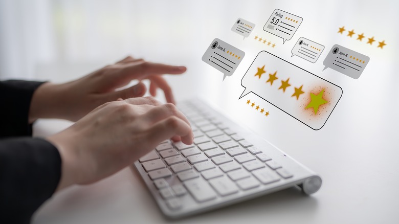 Hands on a keyboard with floating icons showing customer rating and 5 stars
