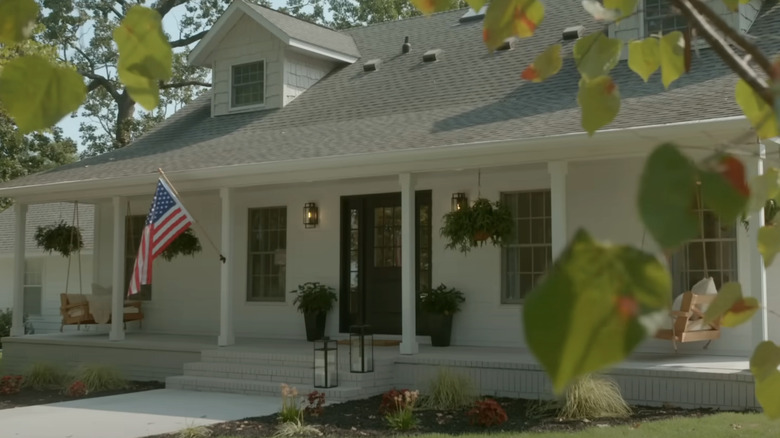 A traditional house exterior with an American flag.