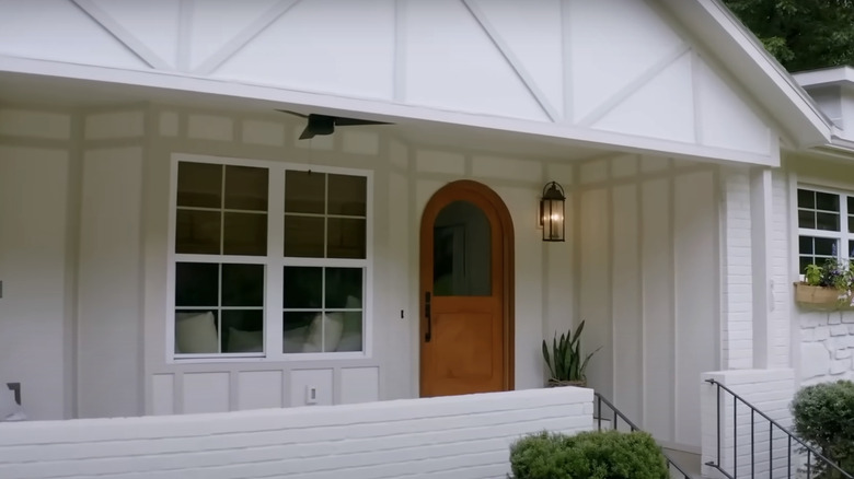 Tudor style home with an arched front door.