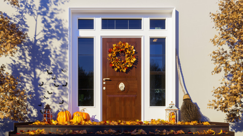 Front entryway with pumpkins and orange leaves
