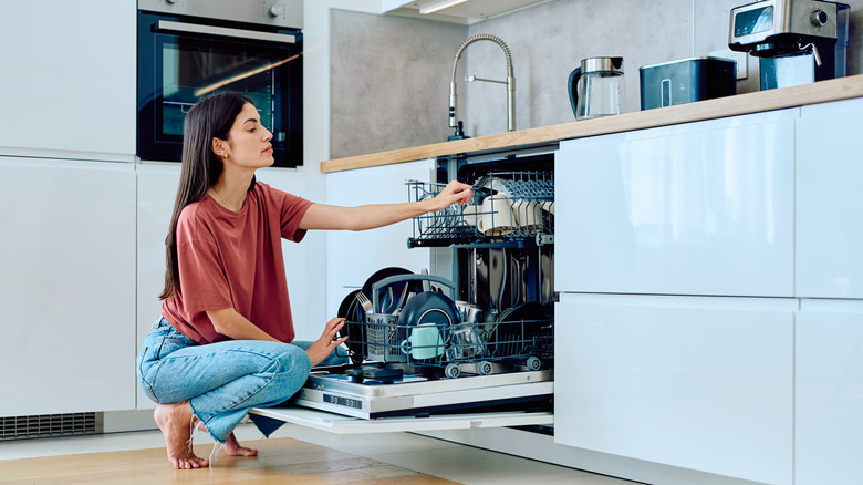 woman loading dishwasher
