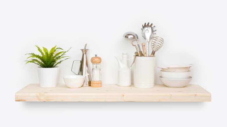 kitchen utensils on wood shelf