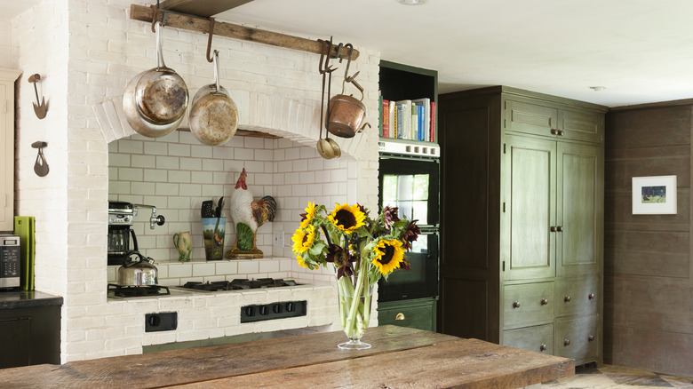 A farmhouse kitchen with an oven framed by a cream brick surround
