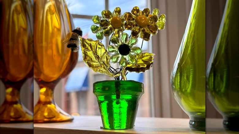 1960s era lucite flower bouquet sitting on a shelf.