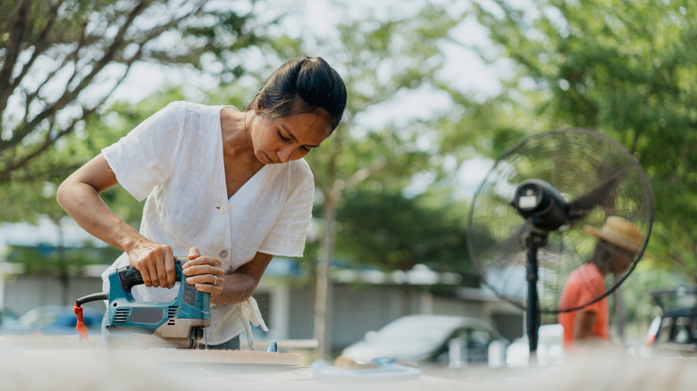 Person using a jigsaw to cut wood