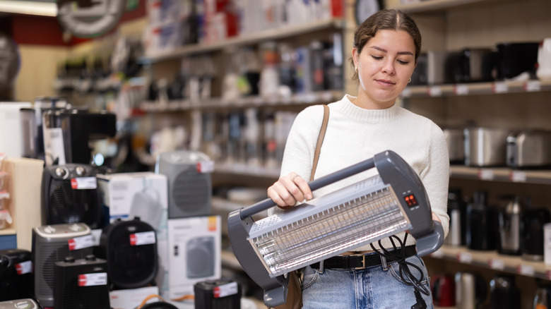 Woman buying a portable heater in a store