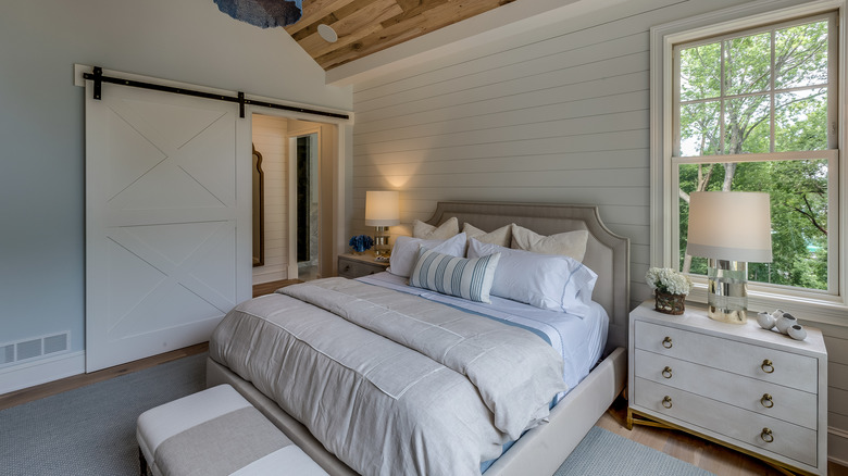 Bedroom of modern farmhouse with sliding door