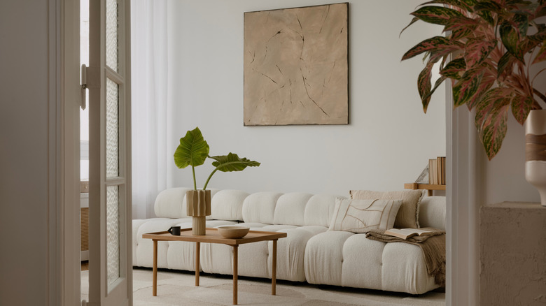 Cosy and stylish interior design of living room with modular white sofa