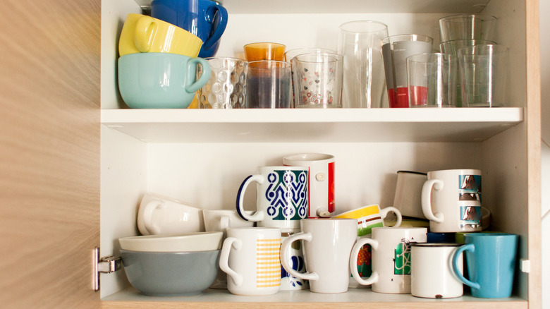 Cluttered coffee mug and cup cabinet