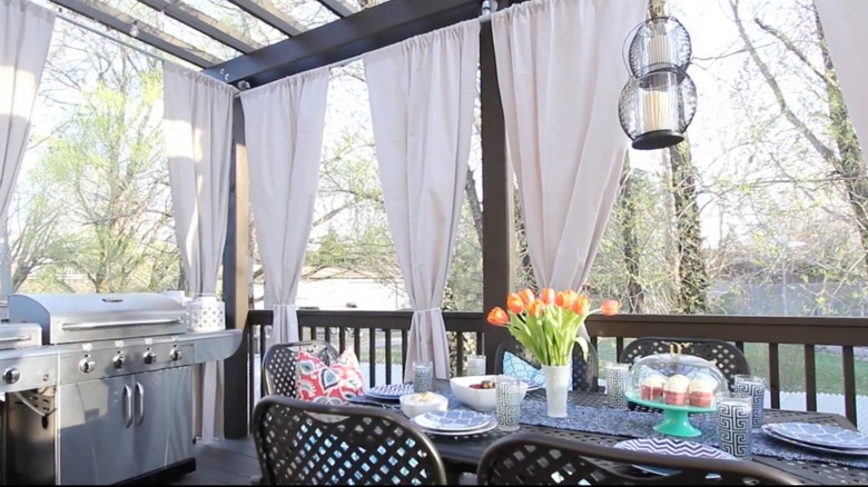Back patio privacy curtains made from galvanized pipe and drop cloth.