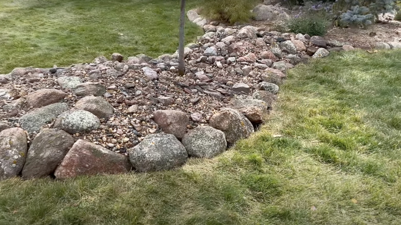 natural stone bed on wispy lawn