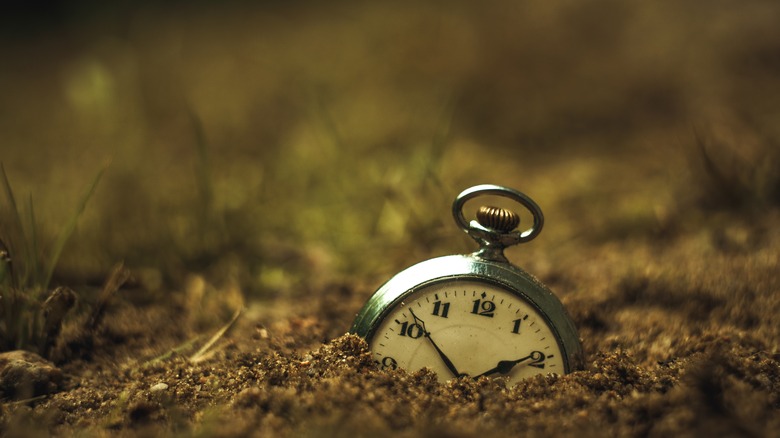 Partially buried alarm clock