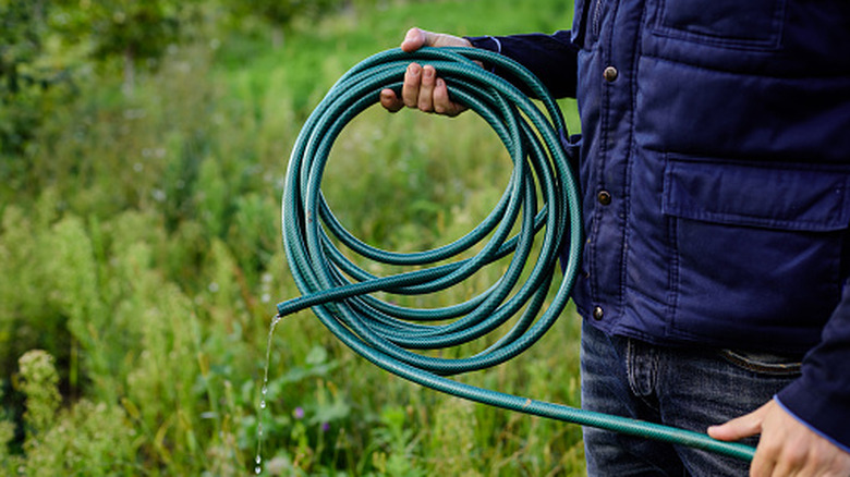 Man holding a garden hose