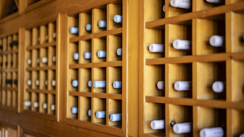 Wooden wine rack with bottles.