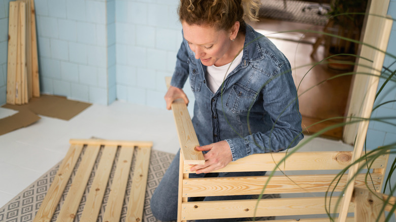 Woman building a wooden bench
