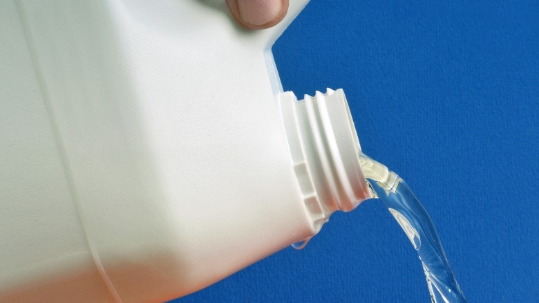 Closeup of pouring bleach out of bottle