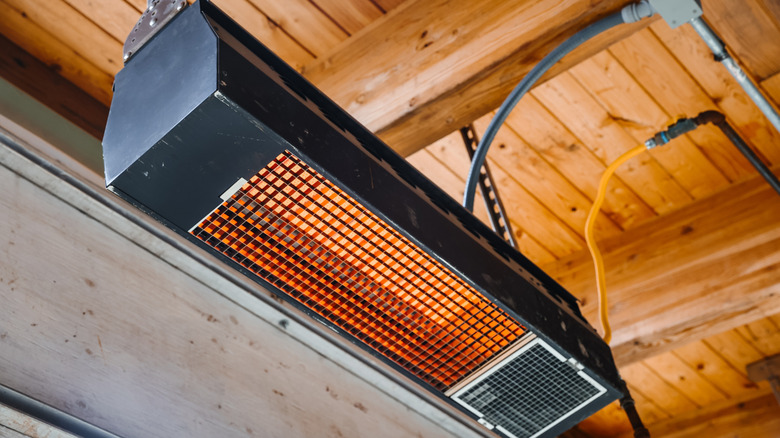 Electric heater plugged in in a garage.