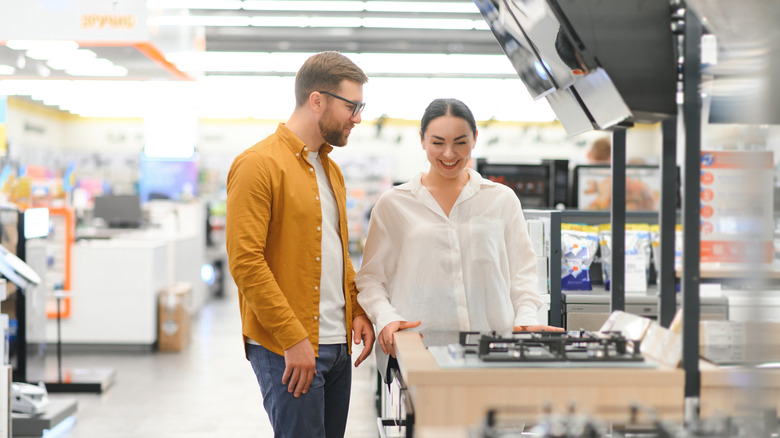 A couple shopping for a new gas stove