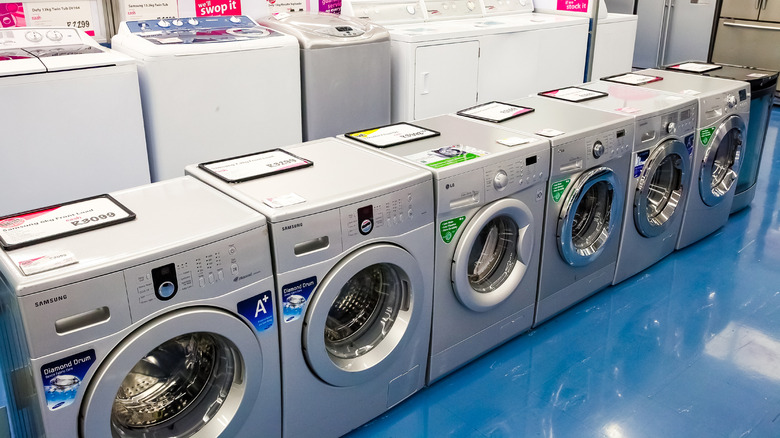 rows of washers and dryers in a store