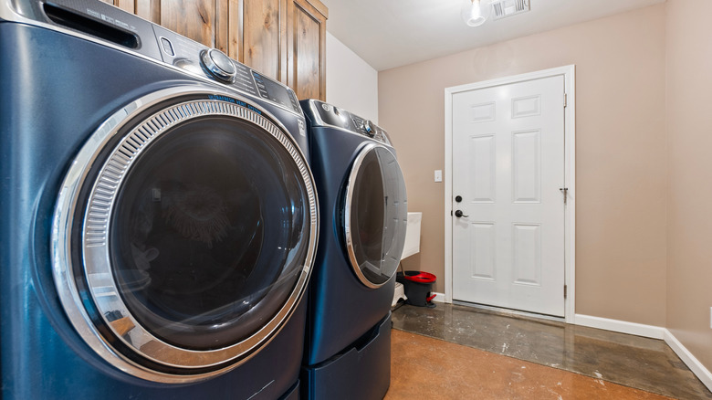 Blue washer and dryer in a laundry room