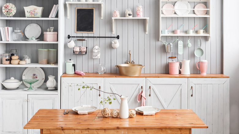 A country kitchen with open shelving and butcher block countertops.