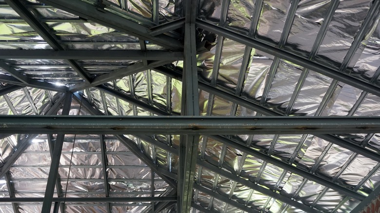 Foil-lined insulation against roof