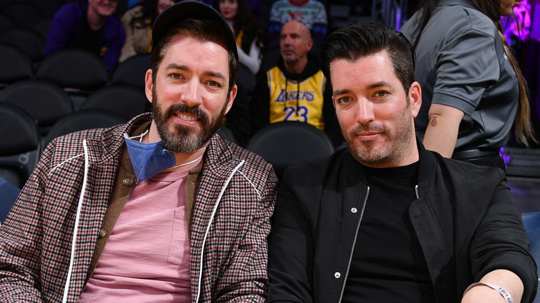  Property Brothers sitting down smiling