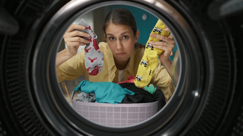 woman mismatched socks laundry machine