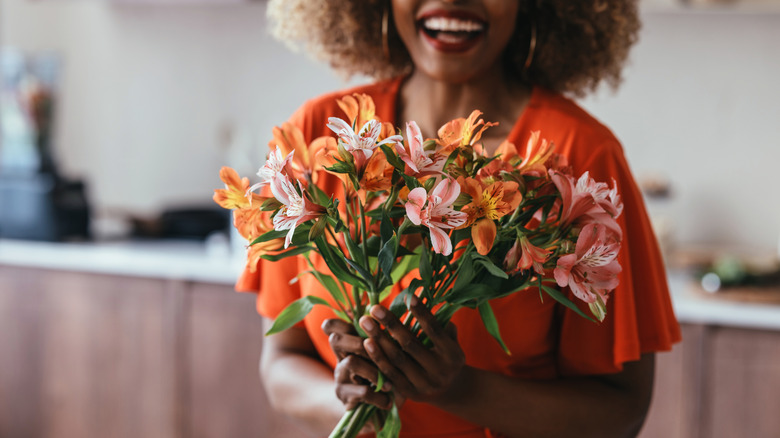 Smiling woman holding flowers