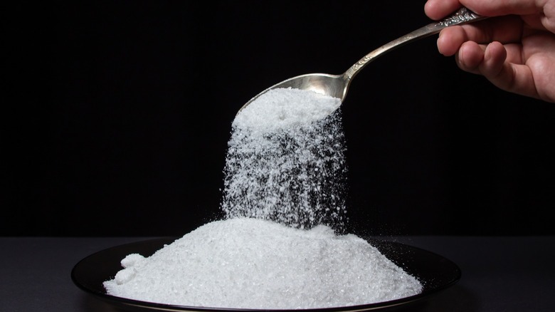 Spoon pouring salt into bowl