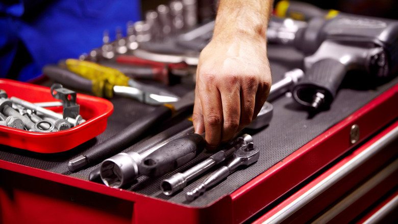 Someone grabbing a tool