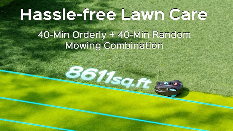 Black smart mower Yardcare M800 Plus mowing straight lines in lawn