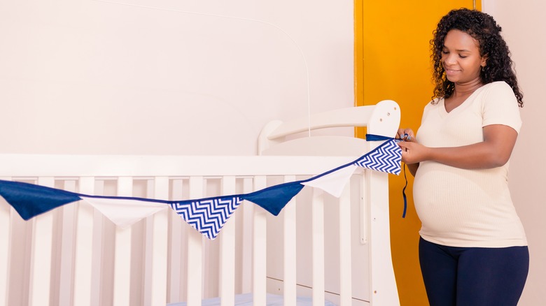 Pregnant woman decorating nursery