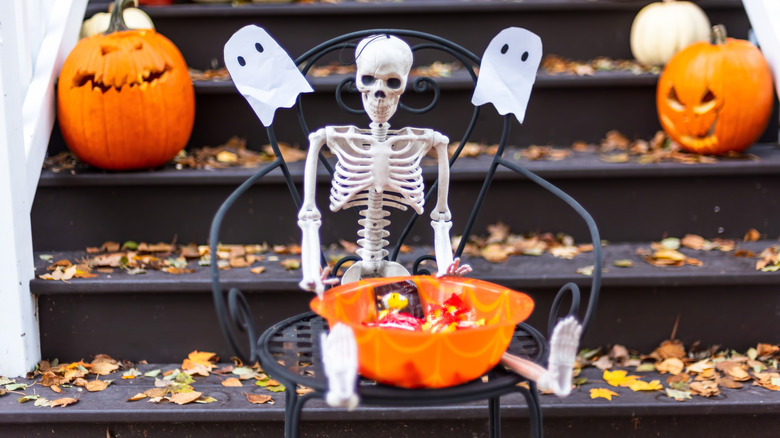 skeleton holding candy bowl 