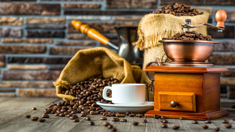 coffee beans, grinder, and cup