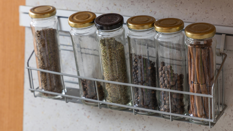 Bottles of spice in a metal rack