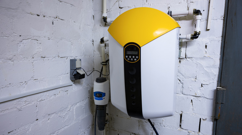 Water softening and descaler system for water treatment mounted to a wall