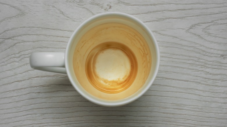 A white coffee mug with coffee stains inside