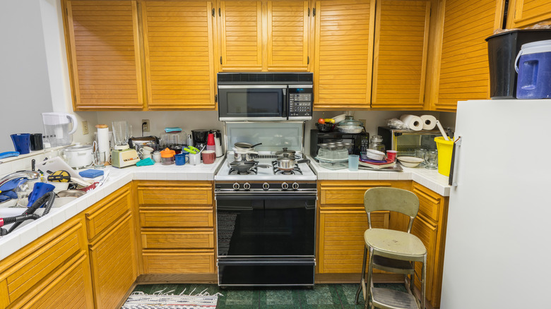 cluttered kitchen with many appliances