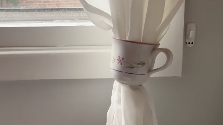 A vintage teacup as a curtain tie-back.