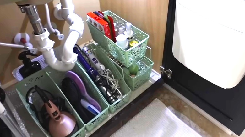 Hair tools including brushes and hair dryers arranged in Dollar Tree book bins
