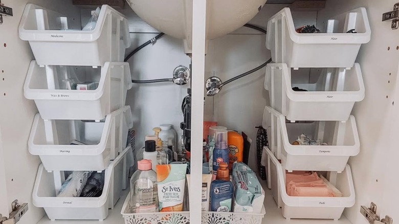 Stackable shelf under bathroom cabinet with labels for different products