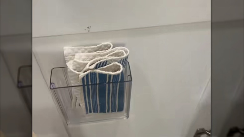 Stackable drawer hanging on the side of the cabinet door with Swedish dish cloths
