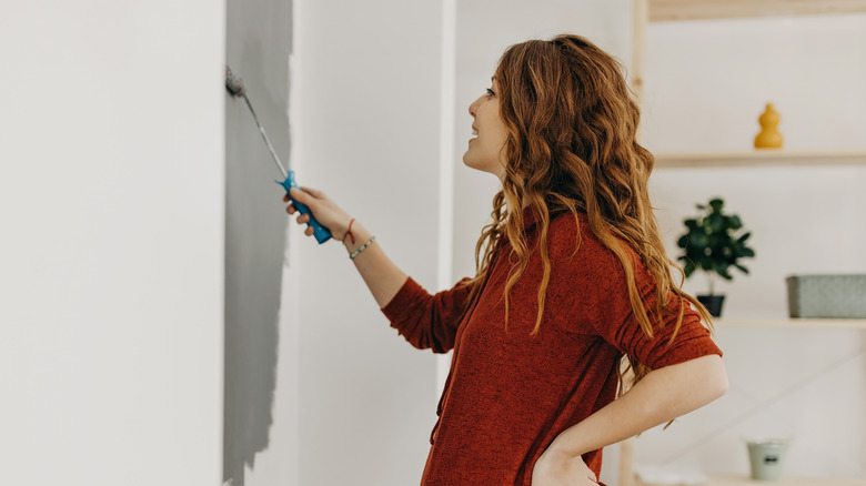 woman painting with gray paint 