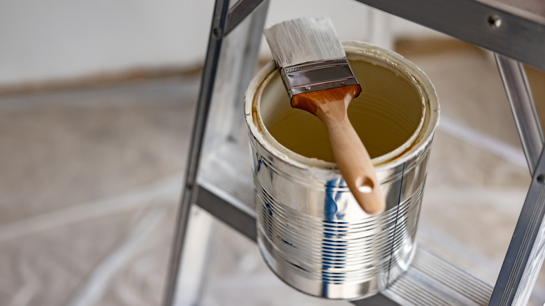 empty paint can on ladder 